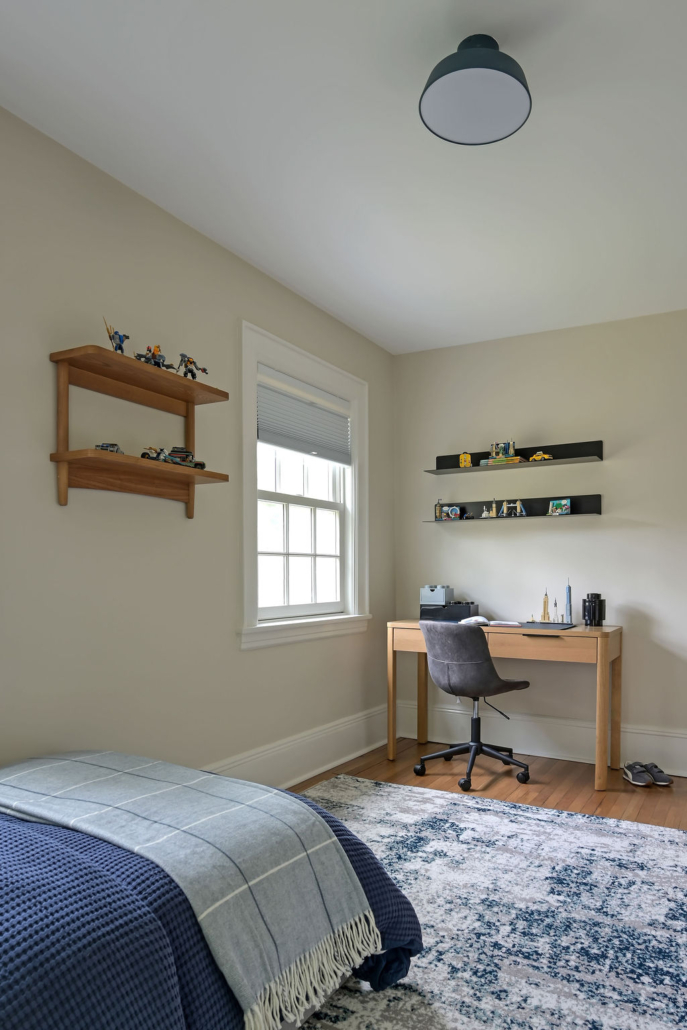 Alternate boys’ bedroom angle highlighting workspace area and tailored, age-appropriate decor.