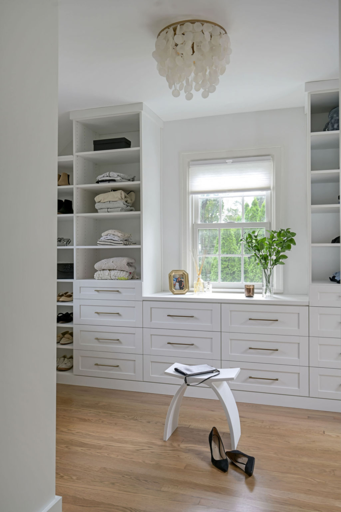 Minimalist, contemporary and urban penthouse interior home office design by Orlie Katsiris Staging & Interiors featuring modern furniture, a black standing desk, white ergonomic chair, and a gray geometric area rug