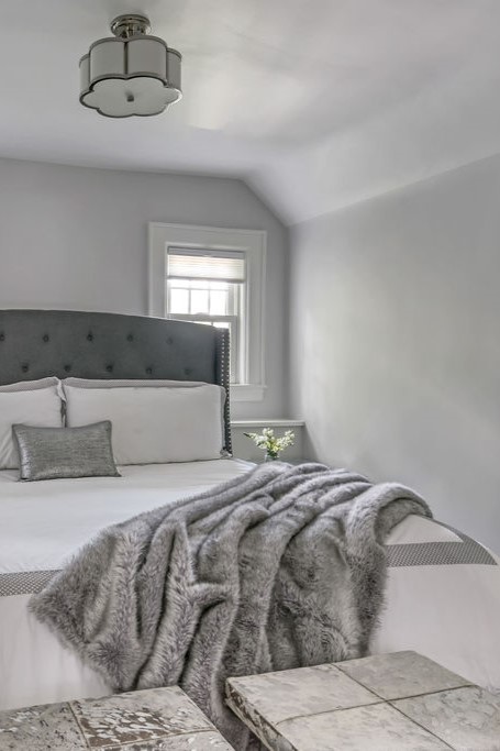 Guest bedroom styled with layered textiles, neutral palette, and inviting hotel-like comfort.