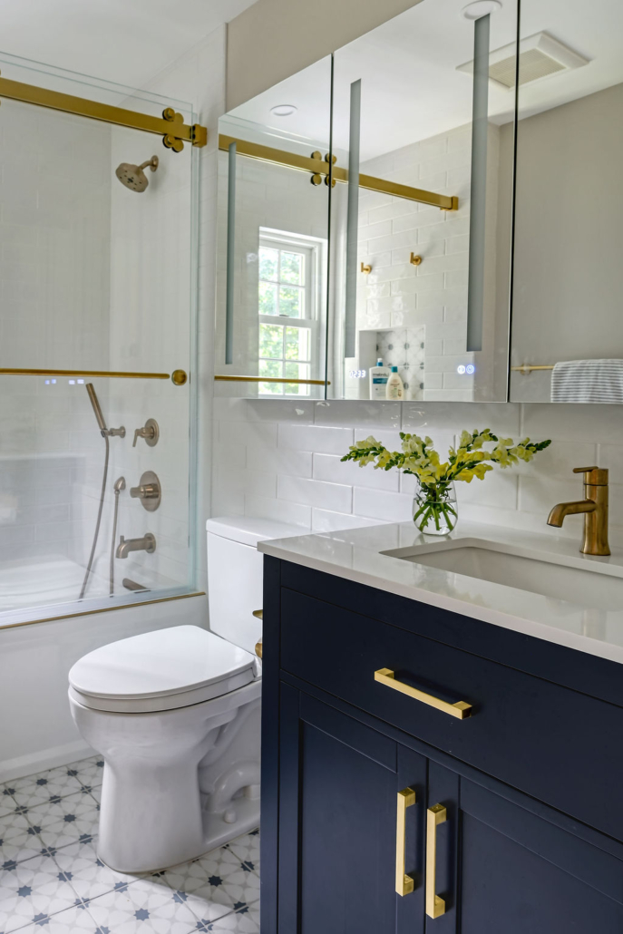Kids’ bathroom with navy vanity, brass hardware, and bright, functional design.