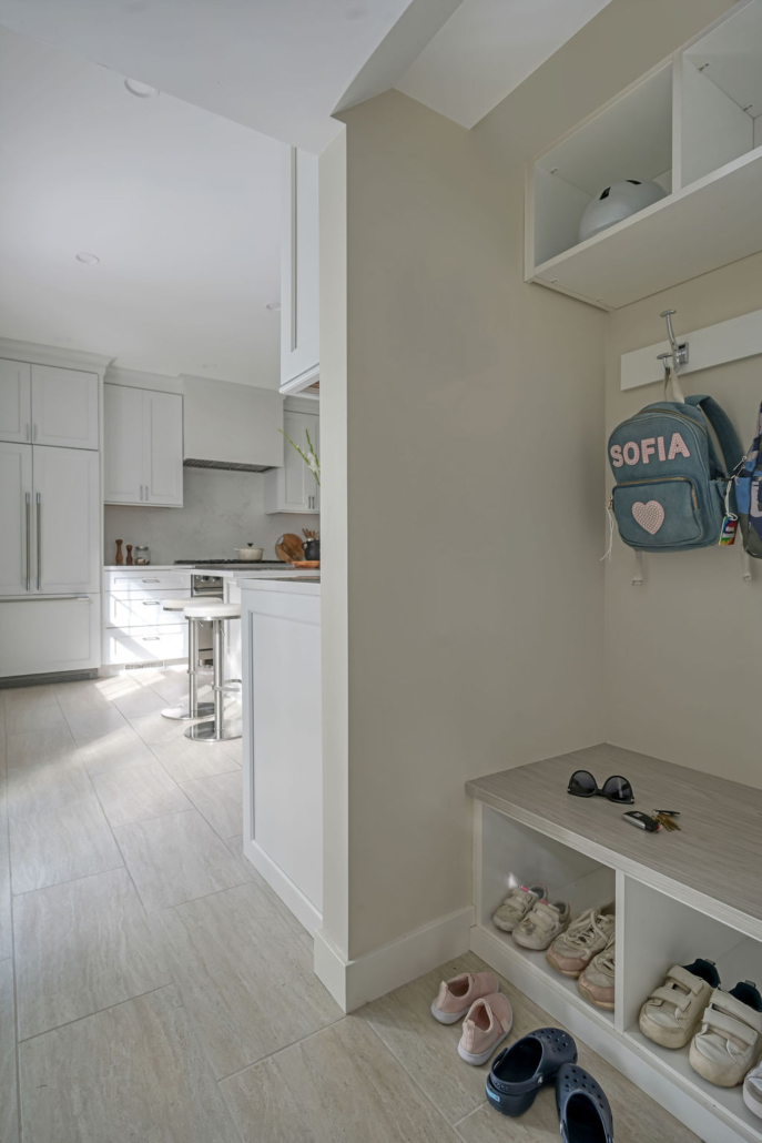 Minimalist, contemporary and urban penthouse interior home office design by Orlie Katsiris Staging & Interiors featuring modern furniture, a black standing desk, white ergonomic chair, and a gray geometric area rug