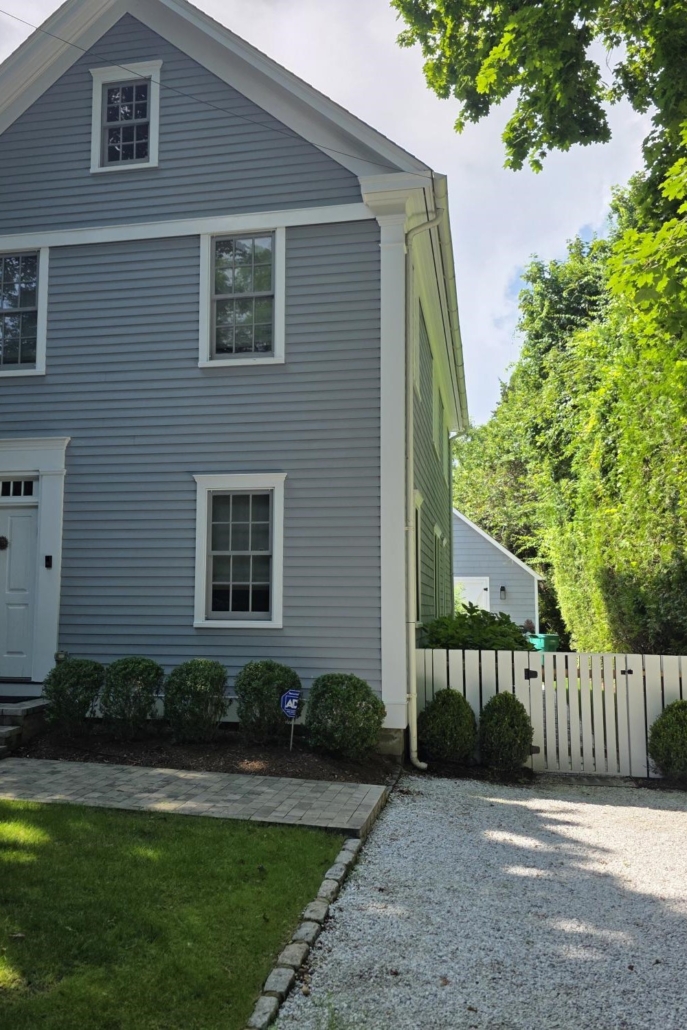 Minimalist, contemporary and urban penthouse interior home office design by Orlie Katsiris Staging & Interiors featuring modern furniture, a black standing desk, white ergonomic chair, and a gray geometric area rug