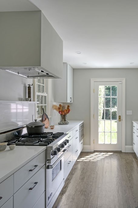 Minimalist luxury penthouse dining room design by Orlie Katsiris Staging & Interiors featuring a RH Porthole Bar.