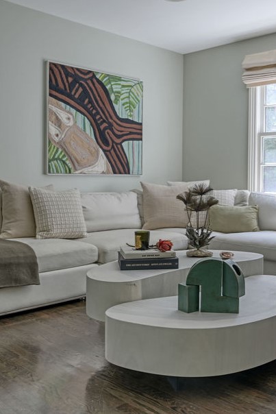 Kitchen design by Orlie Katsiris Staging & Interiors with natural wood cabinetry, vibrant art, and a dark island.