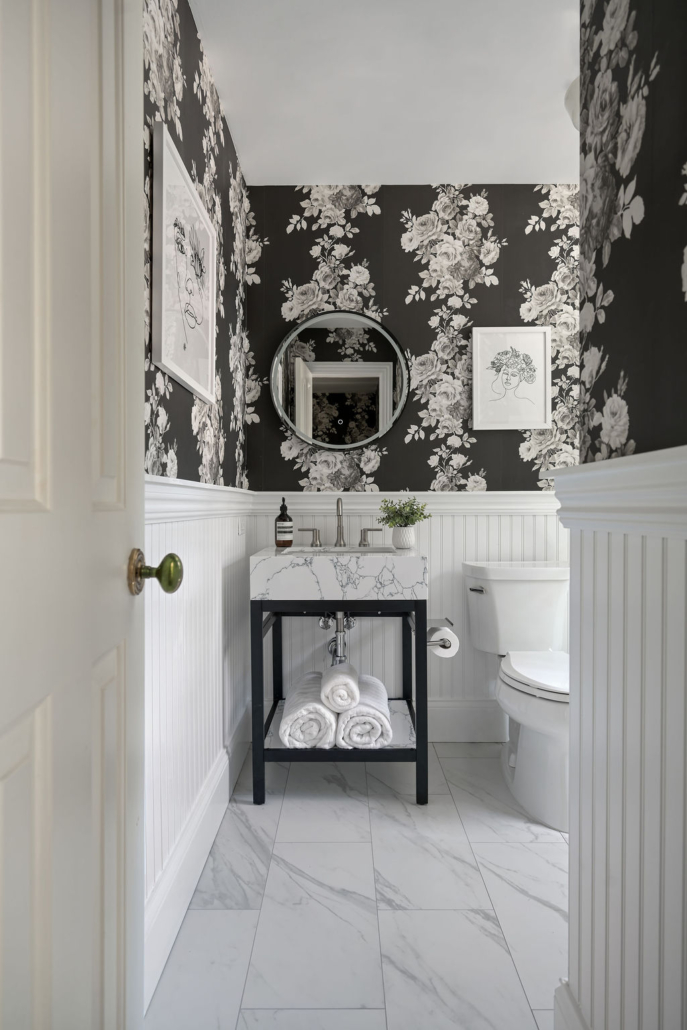 Minimalist, contemporary and urban penthouse interior home office design by Orlie Katsiris Staging & Interiors featuring modern furniture, a black standing desk, white ergonomic chair, and a gray geometric area rug