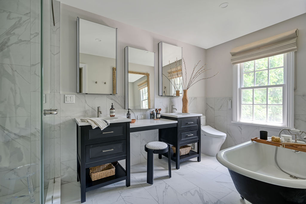 Primary bathroom staged by Orlie Katsiris Staging & Interiors with a double vanity, freestanding tub, and refined modern finishes.