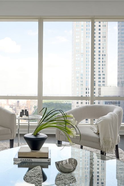 Minimalist luxury penthouse dining room design by Orlie Katsiris Staging & Interiors featuring a RH Porthole Bar.